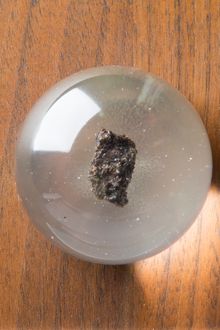 Fragment of moon rock mounted in a Perspex globe with a small Australian flag, carried on board throughout the Apollo 17 mission to the moon and back. 