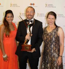 Sydney Harbour YHA staff with the 2013 Qantas Australian Tourism Award for \'Best Backpacker Accommodation\'