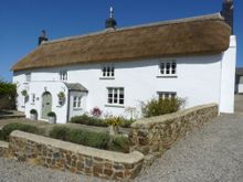 Lake House, a beguilingly beautiful, traditional North Devon thatched cottages with five bedrooms, an enclosed garden, rural vie