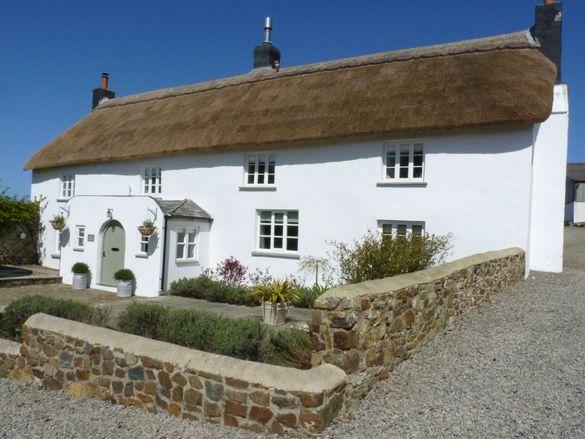 Lake House, a beguilingly beautiful, traditional North Devon thatched cottages with five bedrooms, an enclosed garden, rural vie