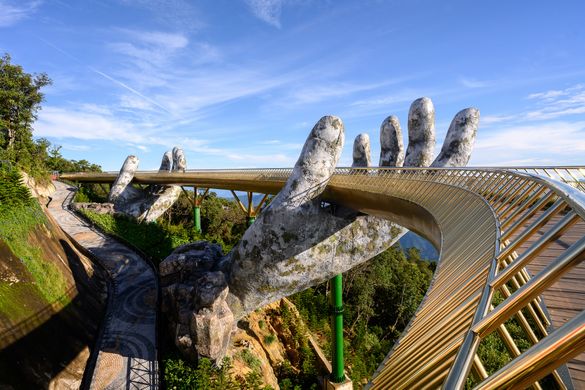 The Golden Bridge is one of the most remarkable tourist sites and a work of art in Ba Na Hill Resort, near Da Nang. Capturing the hearts of travellers worldwide, the bridge features a pair of stone hands reaching out of mountains, creating the illusion th