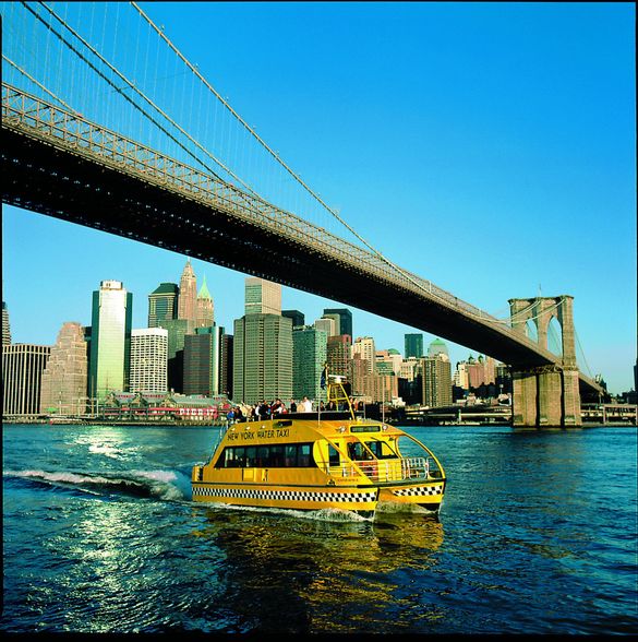 New York Water Taxi Riders Enjoy the Majesty of the Brooklyn Bridge.