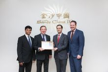 Antonio Ramirez (centre right), Senior Vice President of Human Resources for Venetian Macau Limited, accepts a Bronze Benchmarke