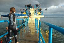 People jumping off the Blackrock diving board at the Salthill Promenade