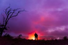 Couple overlooking Halemaumau Crater in Hawaii Volcanoes National Park, Hawaii Island