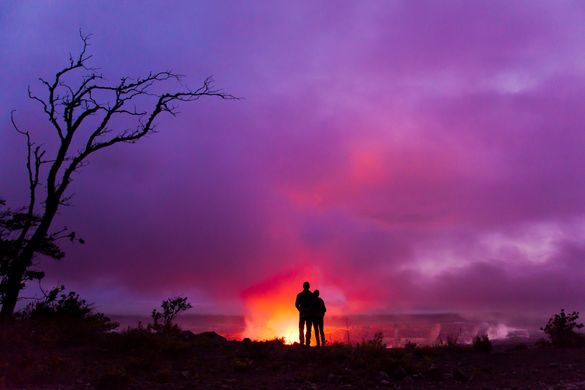 Couple overlooking Halemaumau Crater in Hawaii Volcanoes National Park, Hawaii Island