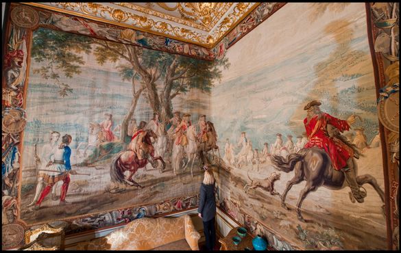 Blenheim Palace's Kate Ballenger inspects the newly restored tapestry