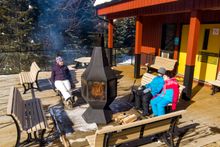 A well-deserved break in the cozy warmth of the fireplace.  Credit: Parks Canada