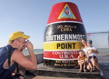Kevin Lazarski of Dover, Wisc., photographs his wife, Dina, and sons, Jacob and Jordan, at the Southernmost Point marker in Key 