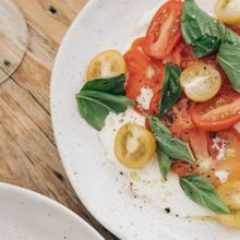 Heirloom tomatoes, basil, stracciatella, Eagle Bay olive oil 