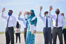 Representatives from the Maldives Ministry of Tourism and MMPRC greet the first tourists to arrive at Velana International Airport. Credit Fayaz Moosa from Sun Media.