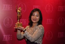 Ann Ge, Regional Sales Manager, accepts a trophy on behalf of The Venetian Macao, named the Best Meetings & Conventions Hotel in