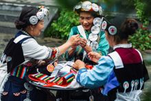 Naxi ladies embroidering their local costume