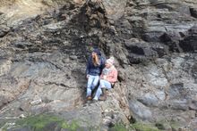 The company's founders soaking up the sunshine on the rocks in Cornwall