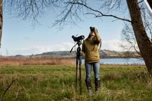 Mya-Rose using the SWAROVSKI OPTIK ATX 25-60x65 Spotting Scope and EL 8.5x42 binocular in Chew Valley Lake. Photo Credit Oliver Edwards. Copyright Dr MC Birdgirl Ltd.