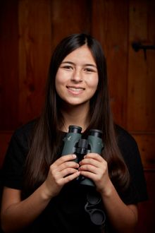 Mya-Rose with SWAROVSKI OPTIK EL 8.5x42 binocular. Photo Credit Oliver Edwards. Copyright Dr MC Birdgirl Ltd.