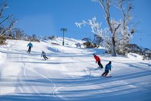 Skiers and snowboarders enjoying the corduroy in Thredbo