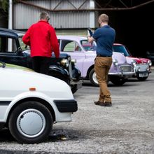 A visitor takes photographs of cars at the 'Drive Dad's Car experience at Great British Car Journey. Thirty-two cars are available to drive around a specially set out circuit.
