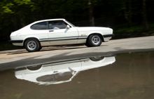 A Ford Capri Laser speeds around a specially set out circuit at the ‘Drive Dad’s car’ expereince - it's one of 32 cars  available to drive at Great British Csr Journey in Ambergate Derbyshire