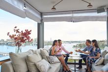 Couples enjoying drinks with Harbour views at Henry Deane cocktail lounge in Hotel Palisade, Millers Point.
