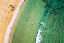 Aerial of paddleboarders at Toowoon Bay, Central Coast.