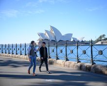Eoghan Lewis from Sydney Architecture Walks with Hayden Quinn walking past Sydney Opera House.
