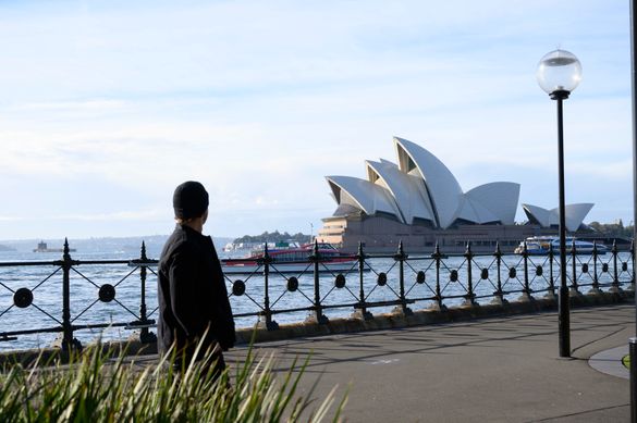 Hayden Quinn walking past Sydney Opera House