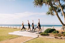 Elements of Byron guests enjoying morning beachfront yoga sessions, Byron Bay