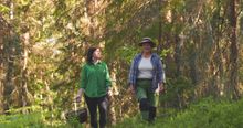 forager and food chemist Lena Engelmark Embertsén and award winning chef Elvira Lindqvist walking in the forest.