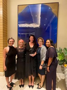 Visit Oxnard Team Accepting Great Workplace Award