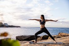 Woman practising yoga at Gordons Bay, Coogee.