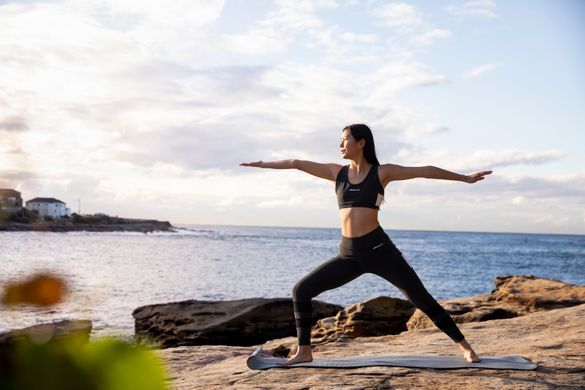Woman practising yoga at Gordons Bay, Coogee.