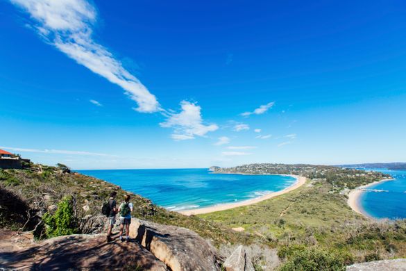 Couple enjoying a scenic coastal hike on the Barrenjoey Lighthouse Walk in Palm Beach, Sydney.