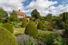Landscaped gardens with Chapel House in the background