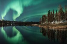   Bands of Northern Lights prominently display over Chena Lake Outdoor Recreation Area during Aurora Season.