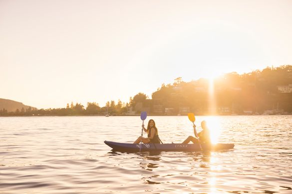 Couple enjoying a sunrise kayaking experience in Pittwater with Pittwater Kayak Tours, Palm Beach