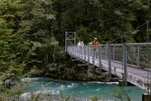 Walkers on swing bridge on Routeburn Track_Blanket Bay Walk