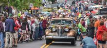A 1941 Cadillac pulls through the crowd in Fairport, NY