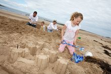 Yellowcraig Beach-Family Digging in Sand-Visit East Lothian