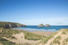 Beautiful Holywell Bay framed by Gull Rocks
