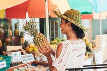 Woman buying a pineapple from a local farmers market