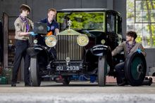 Explorer Scouts Alex Raisin-Moss, 16 (L) and Miles McCarthy, 17 (R) work on their founder’s car at the Great British Car Journey with Apprentice Heritage Vehicle Technician, Luke Henshaw (C), to gain their Mechanic Activity Badge.