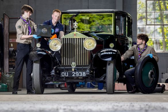 Explorer Scouts Alex Raisin-Moss, 16 (L) and Miles McCarthy, 17 (R) work on their founder’s car at the Great British Car Journey with Apprentice Heritage Vehicle Technician, Luke Henshaw (C), to gain their Mechanic Activity Badge. Explorer Scouts Alex Raisin-Moss, 16 (L) and Miles McCarthy, 17 (R) work on their founder’s car at the Great British Car Journey with Apprentice Heritage Vehicle Technician, Luke Henshaw (C), to gain their Mechanic Activity Badge.