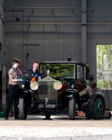 Explorer Scouts Alex Raisin-Moss, 16 (L) and Miles McCarthy, 17 (R) work on their founder’s car at the Great British Car Journey with Apprentice Heritage Vehicle Technician, Luke Henshaw (C), to gain their Mechanic Activity Badge.