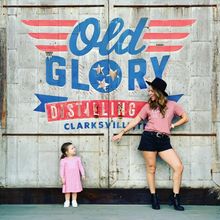 Mother and daughter pose by Old Glory Distilling's mural