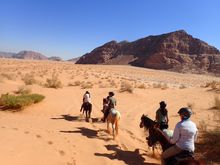 Horse riding across Jordan's lunar like landscape