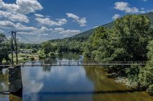 Twin River Outfitters offers kayaking, t ubing and multi - day paddling trips on the Upper James River in Botetourt County, VA. Visitors can paddle under or walk across the historic Buchanan Swinging Bridge , portions of which date back to 1851.