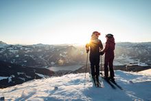 A couple on skis in the morning sun