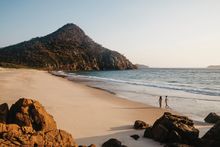 Couple enjoying a walk along Zenith Beach, Port Stephens