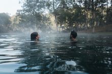Couple enjoying a dip in the natural thermal springs in the Yarrongobilly area, Kosciuszko National Park